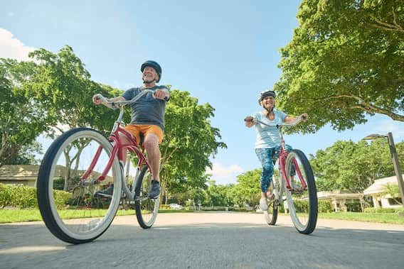 Senior woman and man riding bikes