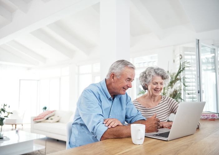 Senior couple embracing technology